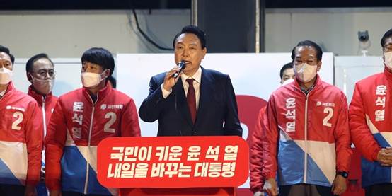South Korean President-elect Yoon Suk-yeol of the main opposition People Power Party celebrating with supporters at the party's headquarters on March 10 in Seoul.