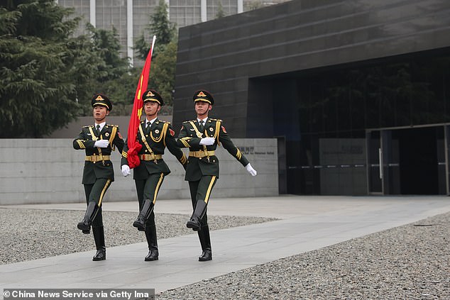 A Chinese army report from 2022 identified 'five battles of cognition' to shape future conflicts. Pictured: The Guard of Honor of the Chinese People's Liberation Army (PLA) perform a flag-raising ceremony