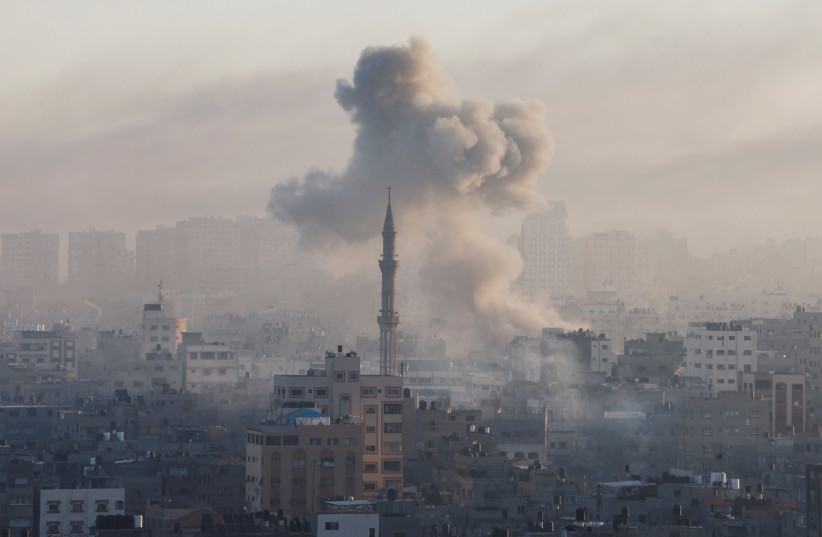 Smoke billows following Israeli strikes amid the ongoing conflict between Israel and the Palestinian Islamist group Hamas, in Gaza, October 13, 2023.  (photo credit: MOHAMMED SALEM/REUTERS)