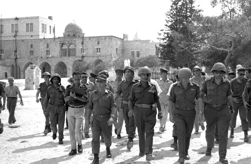  STATUS QUO creator: Defense minister Moshe Dayan (2nd from L.)  walks through the Old City during the Six Day War, 1967, accompanied by chief of staff Yitzhak Rabin, Gen. Rehavam Zeevi and Gen. Uzi Narkiss. (credit: GPO FLICKR)