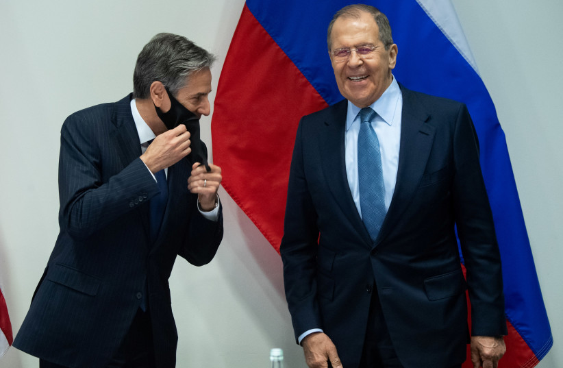US Secretary of State Antony Blinken and Russian Foreign Minister Sergey Lavrov laugh as they arrive for a meeting at the Harpa Concert Hall, on the sidelines of the Arctic Council Ministerial summit, in Reykjavik, Iceland, May 19, 2021 (credit: SAUL LOEB/POOL VIA REUTERS)