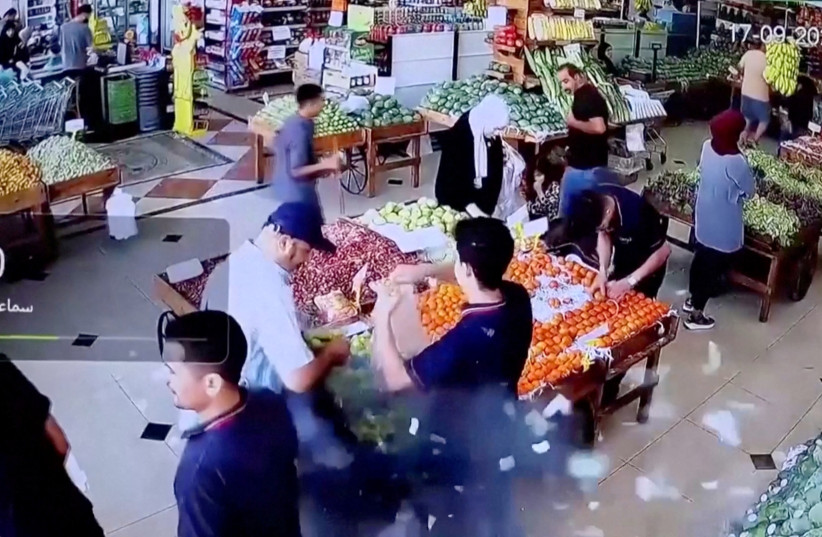  A man's bag explodes in a supermarket in Beirut, Lebanon September 17, 2024 in this screen grab from a video obtained from social media. (credit: Social Media/via REUTERS)